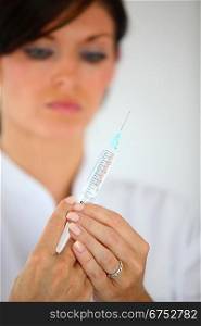 Nurse preparing syringe