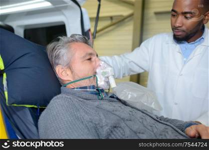 nurse preparing the oxygen mask for patient