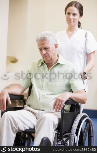 Nurse Pushing Man In Wheelchair