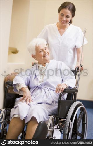 Nurse Pushing Woman In Wheelchair