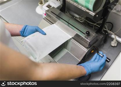 nurse removing plastic from pouch sealer packaging machinery
