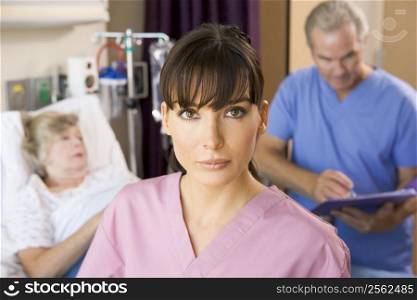 Nurse Standing In Hospital Room,Doctor Making Notes About Patient