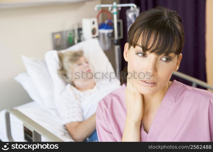 Nurse Standing In Hospital Room,Looking Tired