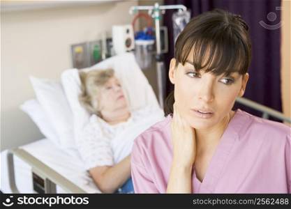 Nurse Standing In Hospital Room,Looking Tired