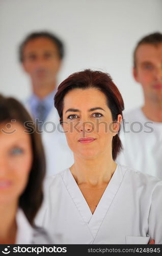 Nurse standing with colleagues