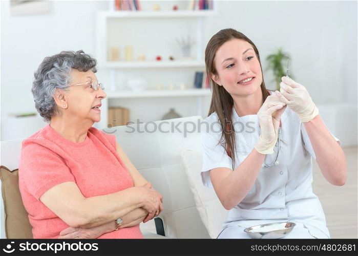 nurse taking blood from an old patient