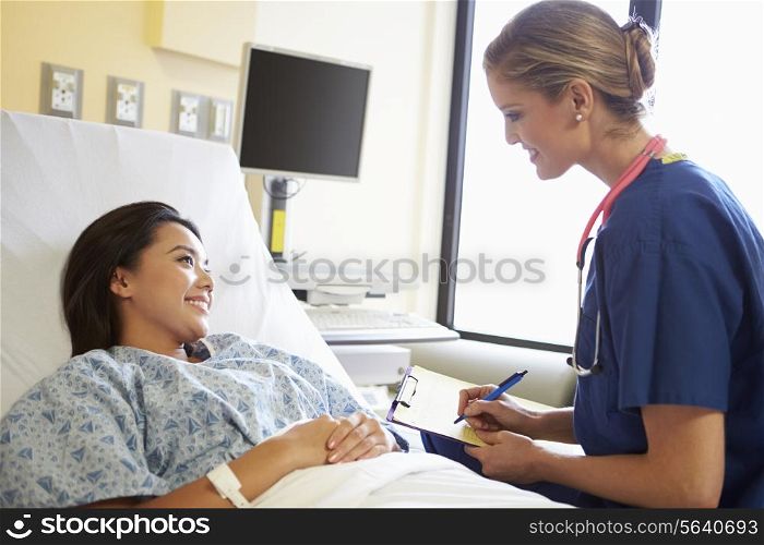 Nurse Talking To Female Patient On Ward