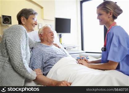 Nurse Talking To Senior Couple In Hospital Room