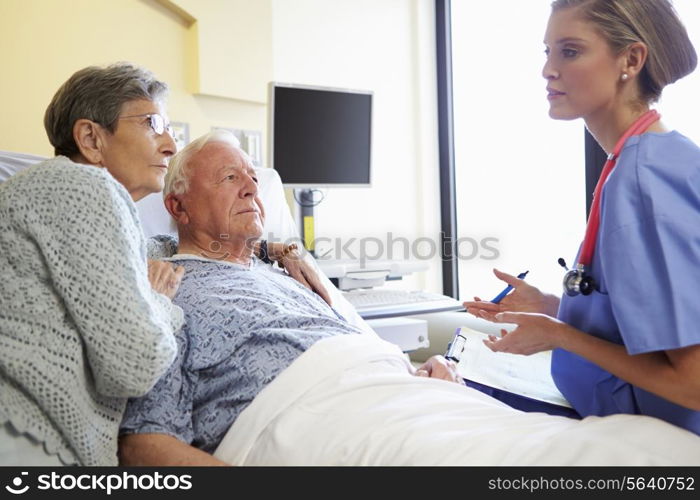 Nurse Talking To Senior Couple In Hospital Room