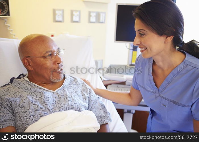 Nurse Talking To Senior Male Patient In Hospital Room