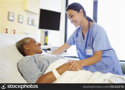 Nurse Talking To Senior Woman In Hospital Room