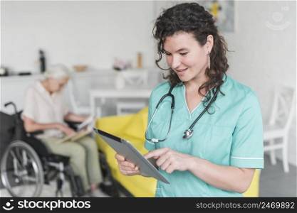 nurse touching digital tablet