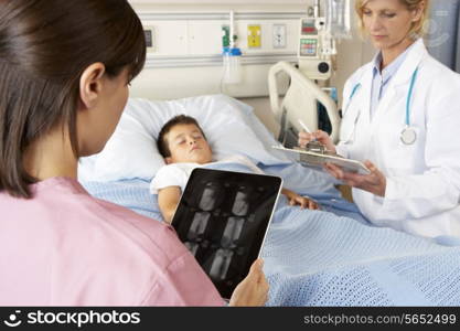 Nurse Using Digital Notepad Whilst Visiting Child Patient