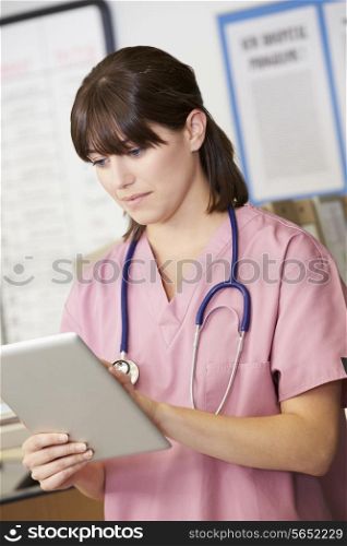 Nurse Using Digital Tablet At Nurses Station