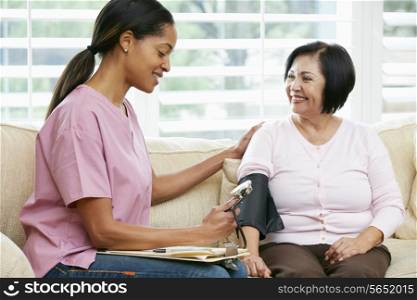 Nurse Visiting Senior Female Patient At Home