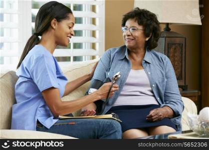 Nurse Visiting Senior Female Patient At Home