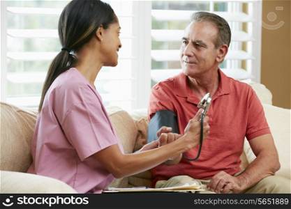 Nurse Visiting Senior Male Patient At Home