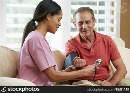 Nurse Visiting Senior Male Patient At Home