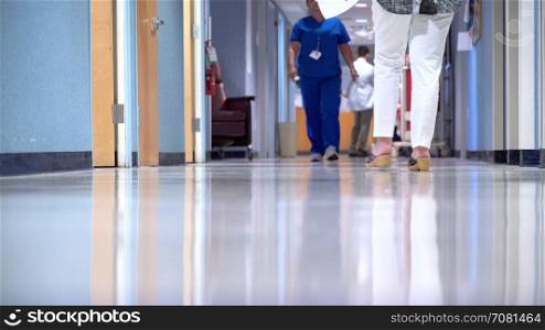 Nurse walks by an administrator