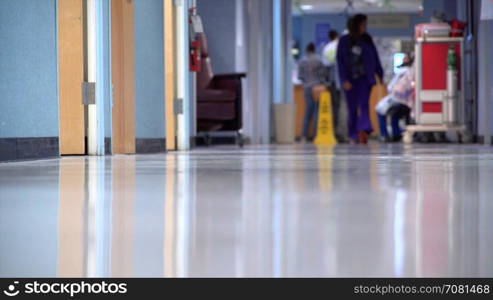 Nurse walks down a hospital hallway