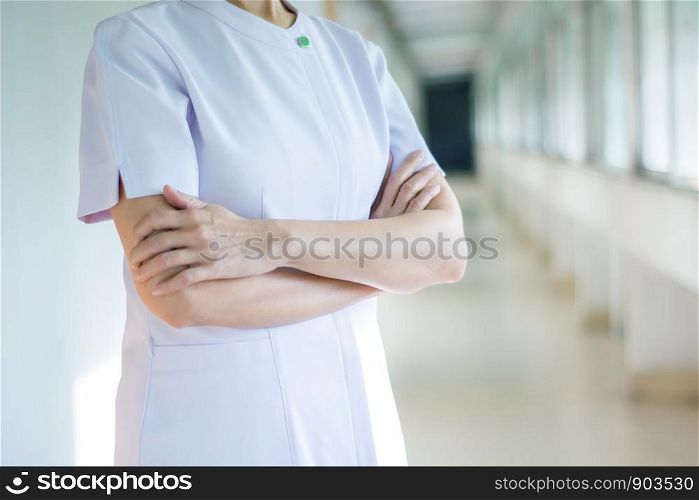 Nurse wearing white medical robe and crossed her arms,female in white uniform.health care and pharmacology concept.