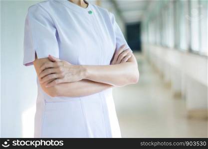 Nurse wearing white medical robe and crossed her arms,female in white uniform.health care and pharmacology concept.