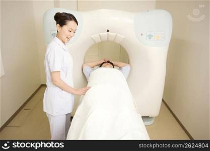 Nurse with a patient having a CT scan