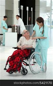 Nurse with an elderly lady in a wheelchair
