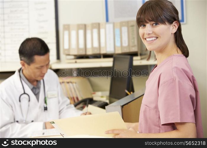 Nurse With Doctor Working At Nurses Station