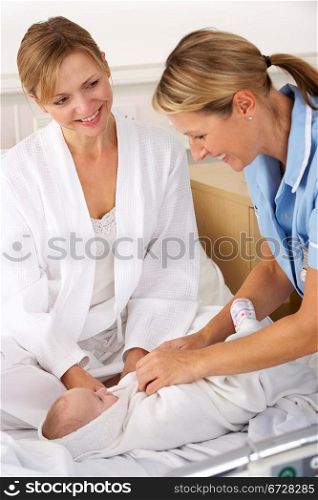 Nurse with mother and newborn baby