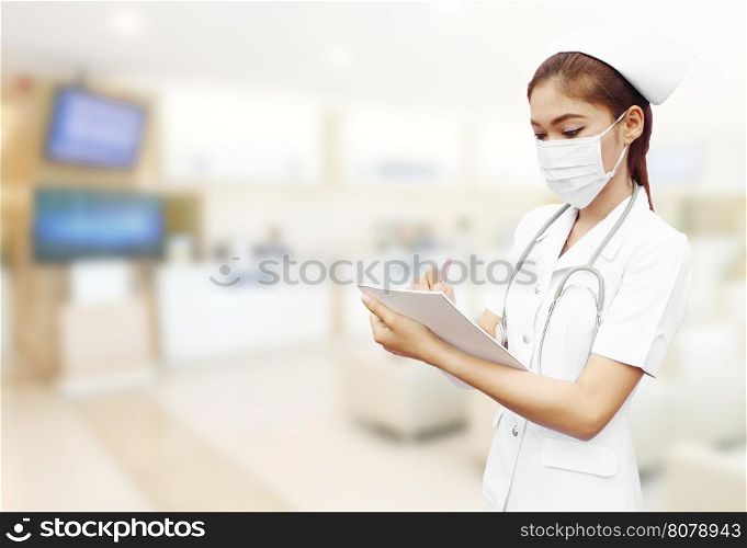 nurse with stethoscope writing medical report in hospital background
