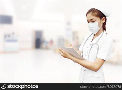 nurse with stethoscope writing medical report in hospital background