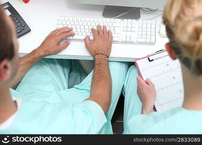 Nurses working at a desktop computer