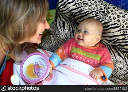 nursing of little baby. nursing of little baby from childish spoon