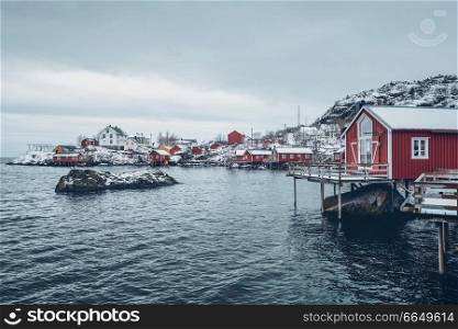 Nusfjord authentic traditional fishing village with traditional red rorbu houses in winter in Norwegian fjord. Lofoten islands, Norway. Nusfjord fishing village in Norway