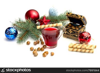 nutlets, tea and coniferous branch with Christmas tree decorations, a still life, the subject Christmas and New Year