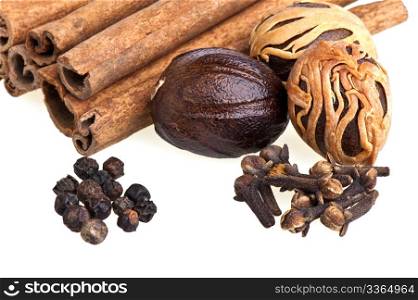 nutmeg, cinnamon, cloves and pepper on white background. nutmeg, cinnamon, cloves and pepper
