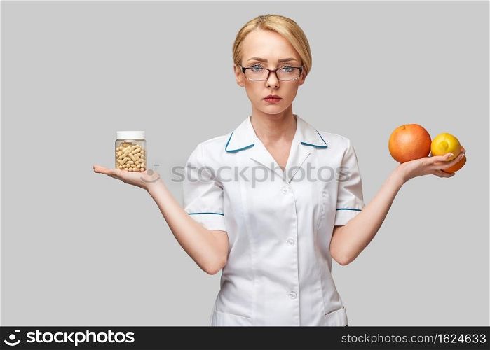 nutritionist doctor healthy lifestyle concept - holding fresh organic citrus fruits - grapefruit, orange, lemon and can of vitamin capsules.. nutritionist doctor healthy lifestyle concept - holding fresh organic citrus fruits - grapefruit, orange, lemon and can of vitamin capsules