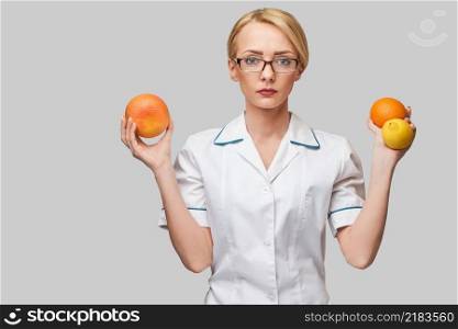 nutritionist doctor healthy lifestyle concept - holding fresh organic citrus fruits - grapefruit, orange and lemon.. nutritionist doctor healthy lifestyle concept - holding fresh organic citrus fruits - grapefruit, orange and lemon