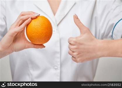 nutritionist doctor healthy lifestyle concept - holding fresh organic orange fruit.. nutritionist doctor healthy lifestyle concept - holding fresh organic orange fruit