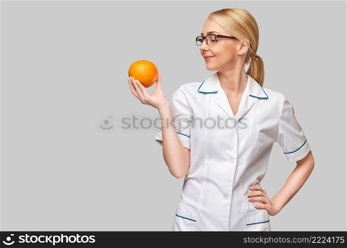 nutritionist doctor healthy lifestyle concept - holding orange fruit.. nutritionist doctor healthy lifestyle concept - holding orange fruit