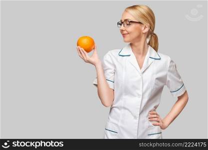 nutritionist doctor healthy lifestyle concept - holding orange fruit.. nutritionist doctor healthy lifestyle concept - holding orange fruit