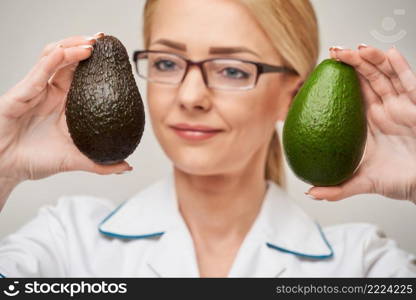nutritionist doctor healthy lifestyle concept - holding organic avocado fruit.. nutritionist doctor healthy lifestyle concept - holding organic avocado fruit