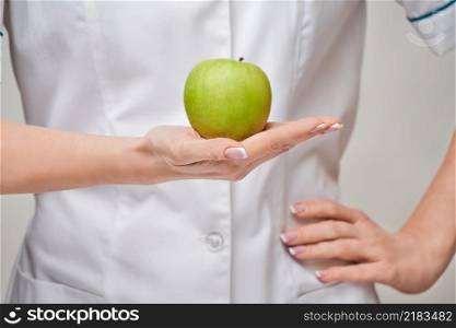 nutritionist doctor healthy lifestyle concept - holding organic fresh green apple.. nutritionist doctor healthy lifestyle concept - holding organic fresh green apple