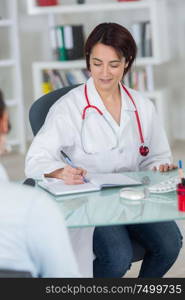 nutritionist doctor writing diet plan in office