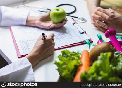Nutritionist giving consultation to patient with healthy fruit and vegetable, Right nutrition and diet concept