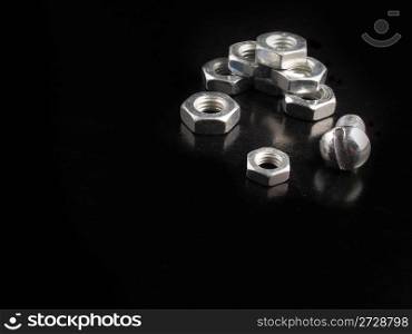 Nuts and bolts on a black background