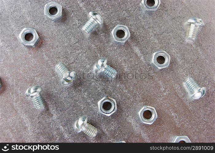 nuts and screws on the metal plate