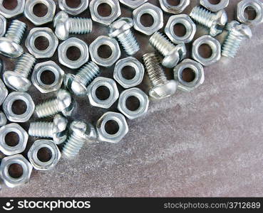 nuts and screws on the metal plate