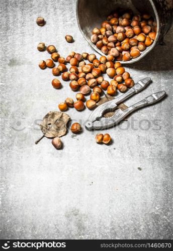 Nuts in the old pot. On the stone table.. Nuts in the old pot.